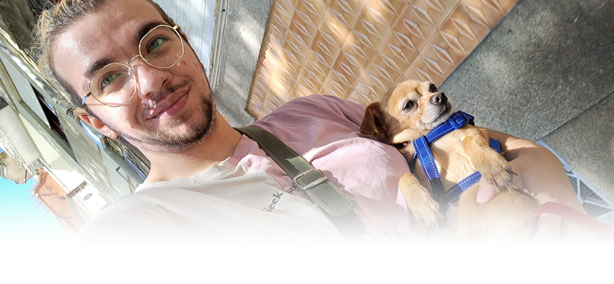 A selfie of me holding a chihuahua named Paco, who is so small that he had to be picked up because he got tired on his walk.